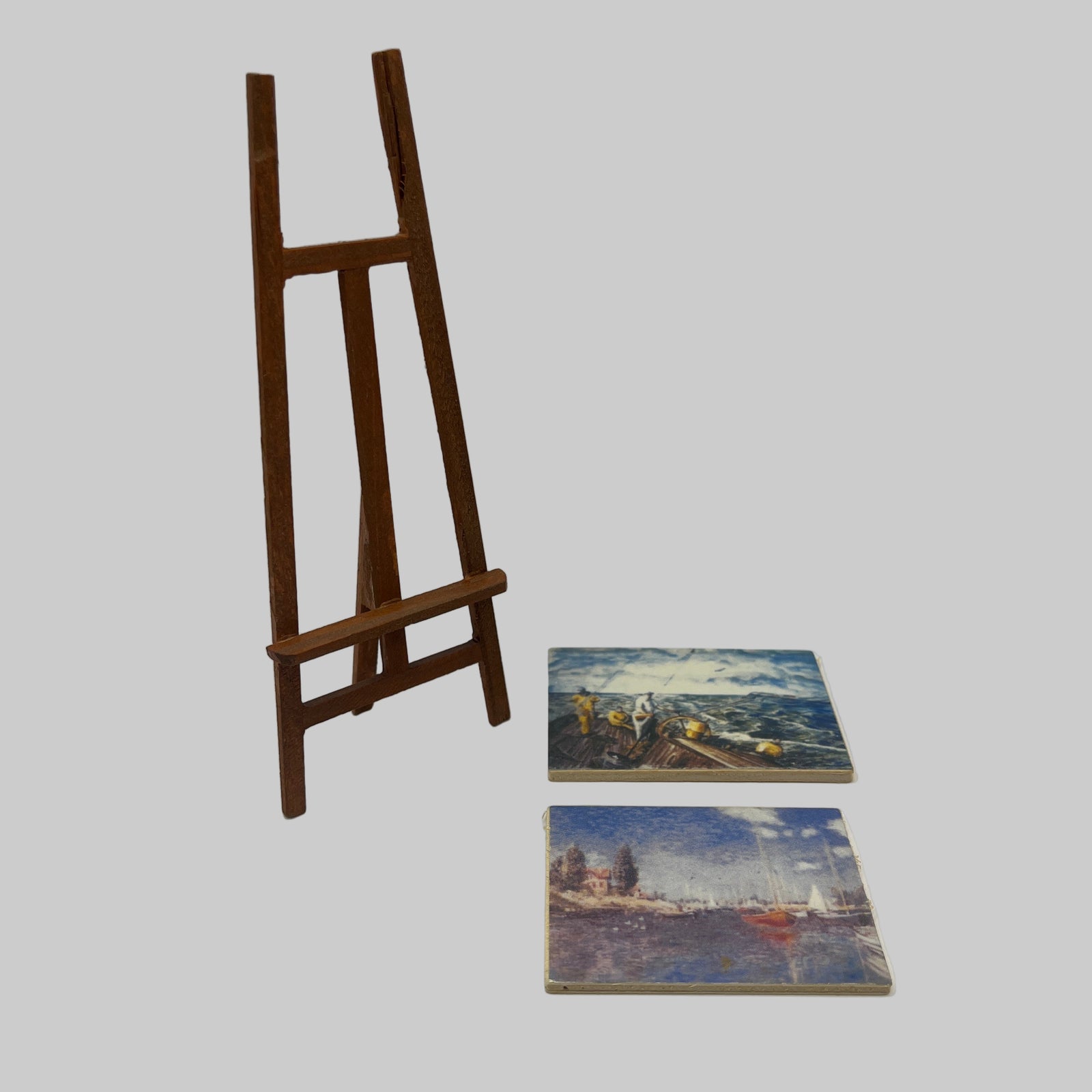 Artists easel with 2 paintings