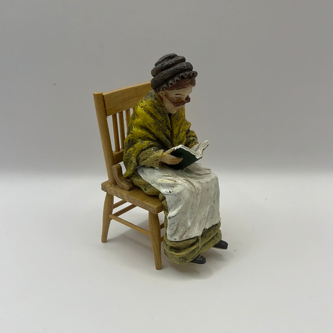 Resin seated old lady reading