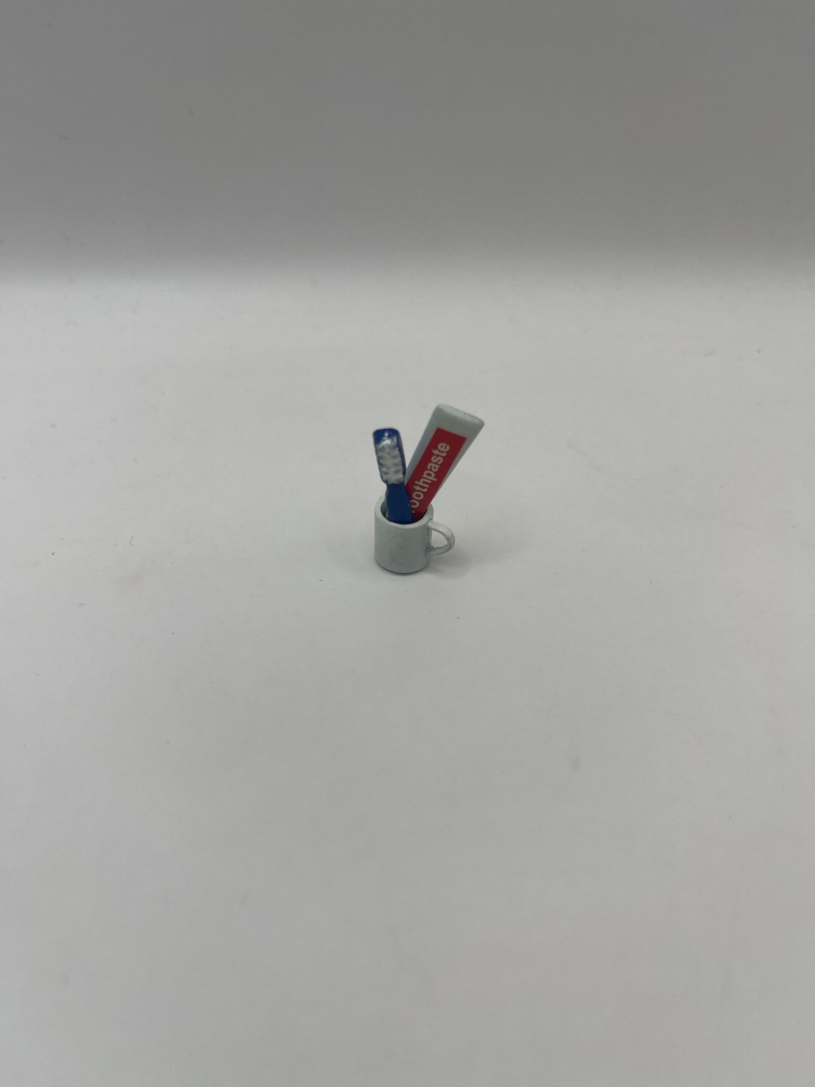 Toothbrush and toothpaste in cup