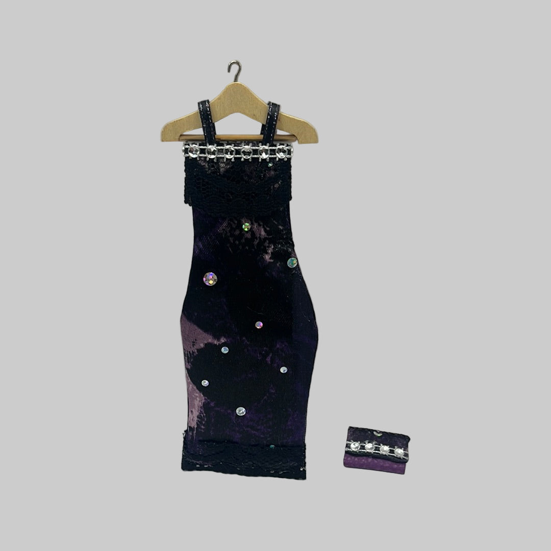 Evening dress on hanger with matching clutch bag
