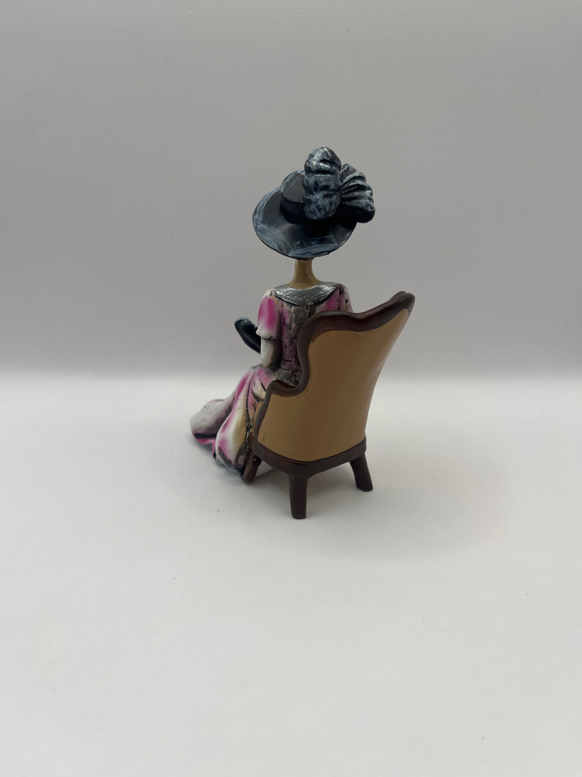 Resin lady with fan in chair