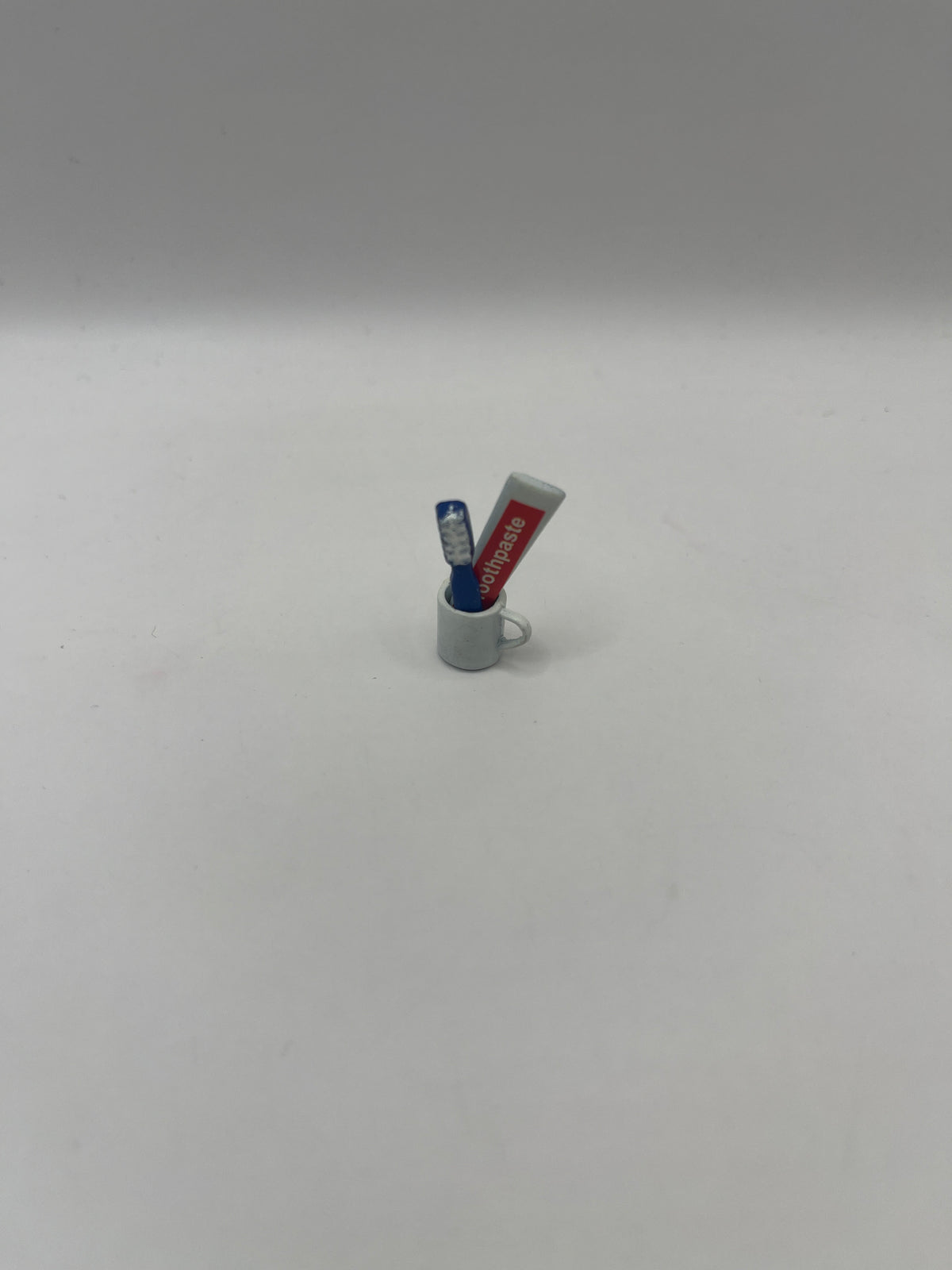 Toothbrush and toothpaste in cup