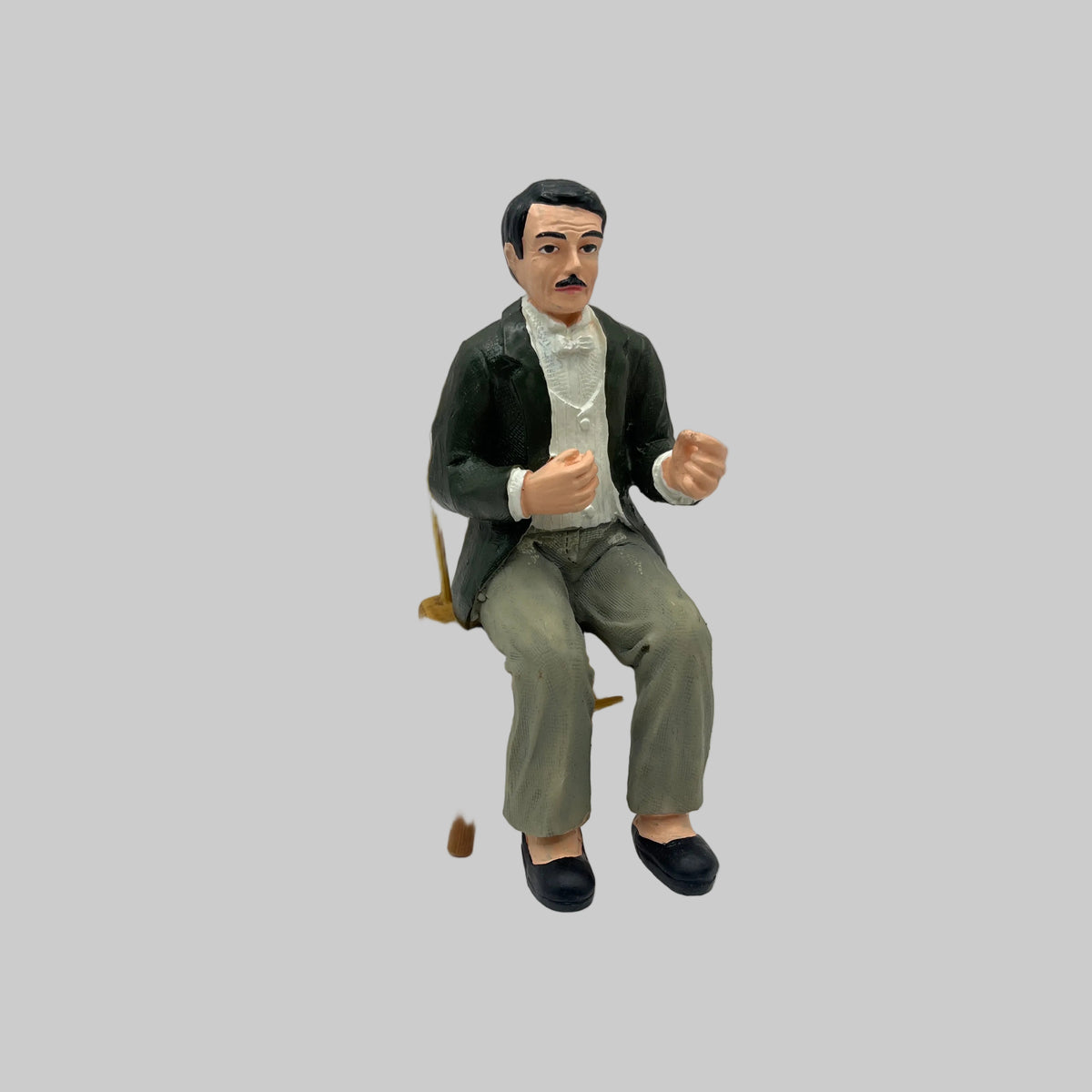 Dolls house seated man with black hair